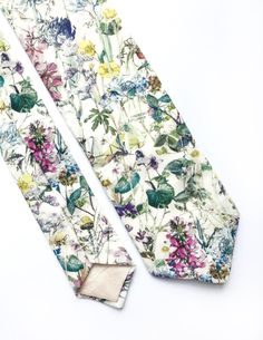 DESCRIPTION: This stunning men's skinny tie has been handmade using a gorgeous wild flower print Liberty cotton. FABRIC: Liberty Cotton. LINING FABRIC: Cotton. -------------------------------------------------------------------------------------------- DETAILS: * Made the traditional way with fabric cut on the bias * Each tie has canvas lining throughout * Fabric lining just at the tip on each end of the tie * Width at the widest part measures approx: 3 inches for standard, 2.5 inches for skinny Spring Floral Print Fitted Suit And Tie Accessories, Spring Floral Print Tie, Summer Floral Print Ties, Summer Floral Print Tie, Summer Floral Print Standard Tie, Summer Floral Print Suit And Tie Accessories, Spring Floral Print Ties As Gifts, Floral Print Tie For Spring Gift, Summer Floral Print Suit And Tie Accessories For Gift