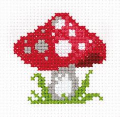 a red mushroom with green leaves on it's side is featured in this cross stitch pattern