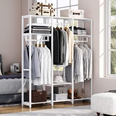 a white closet with clothes and shoes hanging on the rack in front of a window