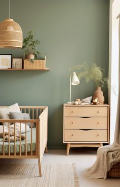 a baby's room with green walls and furniture