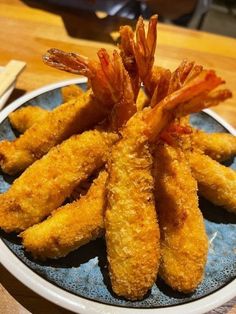 fried shrimp sticks on a plate with dipping sauce