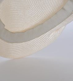 "\"Lou\" is a light cap with a sophisticated lateral fold and a small shield. The slider cap made of the unbleached straw of the Agave is pleasantly air-permeable and very light. The woven type Parasisol results in a fine \"herringbone\" pattern. A hat band sewn in by hand with an invisible stitch ensures a perfect fit and a noble look. I manufacture the cap in the colour \"nature\". The peaked cap can be combined to elegant and sporty outfits. The design is timelessly beautiful, equally perfect Cream Sinamay Hat For Summer, Cream Cloche Sun Hat For Beach, Cream Cloche Straw Hat For The Beach, Cream Cloche Straw Hat For Beach, Beige Sinamay Hat For Summer, Summer Beige Sinamay Hat, Natural Cloche Sun Hat For The Beach, Eco Fashion Design, Invisible Stitch