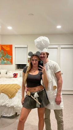 a man and woman dressed up in costumes posing for a photo with a bag on their head