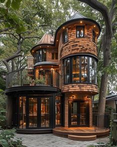 a large wooden house with lots of windows and balconies on the top floor