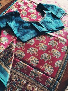 Kalamkari saree in a wine color with blue border that has elephant motifs over the body. It has a beautiful stitched blouse that fits size 36 and can extend to size 38. Fall and pico done. Ready to wear saree. Kalamkari Saree, Ready To Wear Saree, Blue Border, Wear Saree, Wine Colored, Burgundy Color, Dress Clothes For Women, Rock Revival Jean, Alexander Mcqueen Scarf