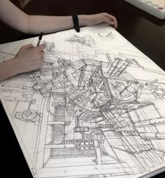 a person is drawing something on a piece of paper