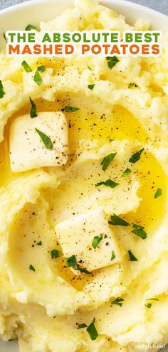 mashed potatoes with butter and parsley on top in a white bowl text reads the absolute best mashed potatoes