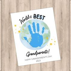 a card with the words world's best grandparents and handprints on it