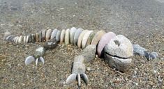 a rock sculpture made to look like a lizard laying on the ground with it's eyes closed