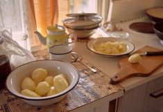 there are many different types of food on the counter in this kitchen, including potatoes and jam