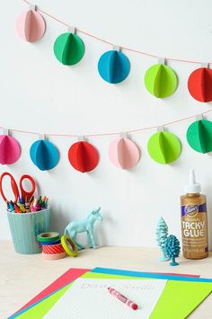 colorful paper decorations and craft supplies on a table