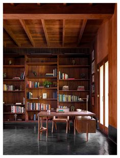 an empty room with bookshelves and tables in it