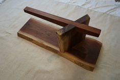 a wooden object sitting on top of a bed