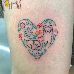 a heart shaped tattoo with sheep and flowers