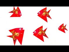 four red fish shaped kites with gold decorations on them