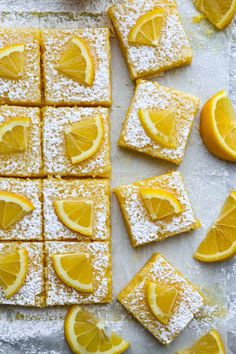 lemon bars with powdered sugar and orange slices