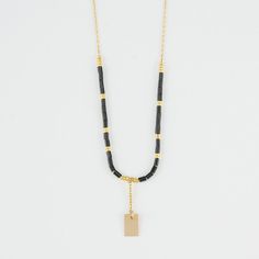 Close-up of delicate gold necklace with black and gold beads shown reverse with adjuster bead. Elegant Black Jewelry With Rectangular Links, Elegant Pendant Beaded Necklace With Chain, Gold Pendant Necklace With Black Beads, Modern Gold Necklace With Beaded Chain, Chic Beaded Necklaces For Gifts, Chic Beaded Necklace For Gift, Modern Beaded Chain Necklace For Gifts, Gold Long Necklace With Black Beads, Elegant Everyday Beaded Necklaces With Adjustable Chain