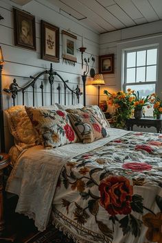 a bed sitting in a bedroom next to a window with pictures on the wall above it