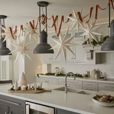 a kitchen decorated for christmas with star decorations