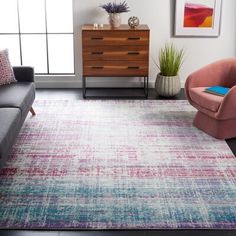 a living room with a couch, chair and rug