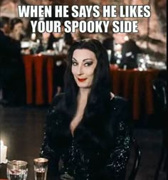 a woman sitting at a table with wine glasses in front of her and the caption reads, when he says he likes your spooky side