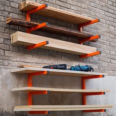 some shelves on the side of a brick building with tools and construction equipment sitting on them