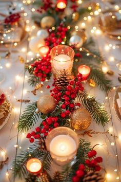 a table topped with candles and christmas decorations