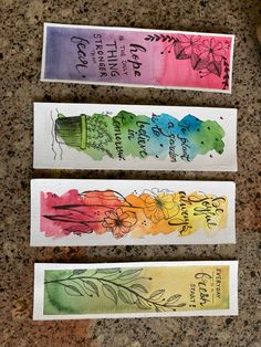 three watercolor papers with writing on them