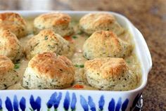 a casserole dish filled with biscuits and sauce