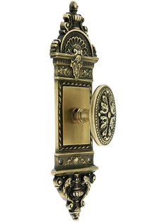 an ornate brass finish wall mounted robe hook