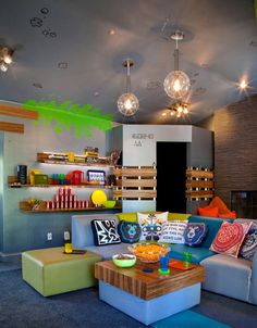 a living room filled with furniture and lots of lights hanging from the ceiling above it