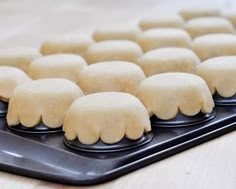 several doughnuts on a tray ready to be made into buns or muffins