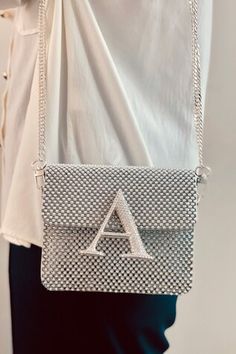 Silver crossbody bag in box shape, envelope flap, stones studded placement alphabet design, pearls and tonal crystals embellishment. Comes with detachable pearl beaded top handle and sling chain. - Aza Fashions Designer Silver Shoulder Bag Gift, Designer Silver Shoulder Bag As Gift, Designer Rectangular Shoulder Bag With Rhinestones, Designer Rhinestone Rectangular Shoulder Bag, Designer Silver Shoulder Bag With Rhinestones, Designer Rectangular Rhinestone Shoulder Bag, Silver Crossbody Bag, Alphabet Design, Beaded Top