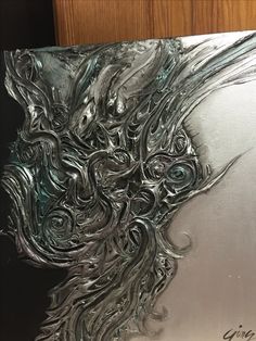 a metal plate with an artistic design on it