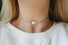 "Pearl Surf Seed Beaded Choker Necklace Beautiful mix of 11/0 ocean blues, whites & iridescent glowing seed beads finished with a unique genuine flat pearl bead Due to uniqueness of each pearl, no two will be the same! This makes each necklace one of a kind! Pearls are approximately 1/2 inch in size Choker measures 13 inches with a 2\" adjustable extender chain. 15 inches full length. Custom lengths are available upon request. Handmade with love by Amanda **please read my shop's policies** T Adjustable Beaded Mother Of Pearl Necklace, Adjustable Pearl White Beaded Choker, White Beaded Pearl Necklace For Festivals, White Mother Of Pearl Beaded Necklace, Handmade Gift Tags, Beaded Choker Necklace, Beach Jewelry, Moon Necklace, Beaded Choker