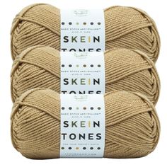 three skeins of yarn in beige colors