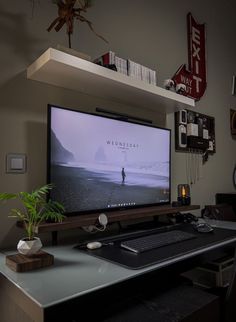 a flat screen tv sitting on top of a desk