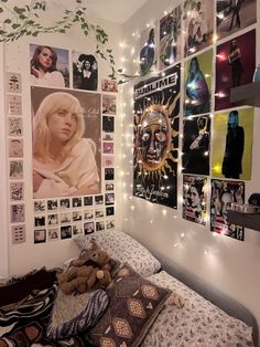 a bedroom with posters and lights on the wall