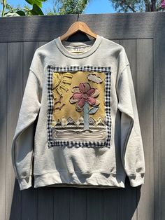 Handmade upcycled boho sweatshirt with flower, mountain, and sun scene. The sweatshirt is brand new and is embellished with a lot of machine stitched detail to create a one of a kind special item - a perfect, easy piece to add character to your summer wardrobe. It would also make a nice gift for women who love the boho vibe. Size: unisex large (a perfect style to wear oversized if you like that look like I do ;) )  *I also have many one of a kind handmade trucker hats made in a similar style if Oversized Patchwork Sweatshirt For Spring, Relaxed Fit Patchwork Crew Neck Sweatshirt, Oversized Cotton Patchwork Sweater, Long Sleeve Patchwork Sweatshirt For Spring, Spring Long Sleeve Patchwork Sweatshirt, Spring Cotton Patchwork Sweatshirt, Sewed Sweatshirt, Oversized Patchwork Cotton Sweatshirt, Patchwork Cotton Sweater For Spring