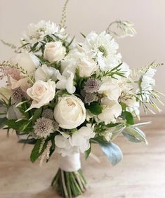 a bouquet of white flowers sitting on top of a table