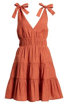 A tiered, ruffled skirt adds playful flounce to this smocked-waist minidress punctuated with ties at each shoulder. 35" length (size Medium) Slips on over head V-neck Side-seam pockets Lined 61% rayon, 27% polyester, 12% nylon Machine wash, line dry Imported Casual Mini Tiered Dress With Ruffled Skirt, Mini Length Tiered Sundress With Ruffle Hem, Casual Mini Length Tiered Dress With Ruffled Skirt, Casual Mini Dress With Smocked Back And Tiered Skirt, Summer Pleated Tiered Dress, Tiered Skirt Sundress With Ruffle Hem, Tiered Skirt Mini Dress With Ruffle Hem, Tiered Mini Dress With Ruffle Hem Sundress, Casual Tiered Ruffle Dress With Ruched Detail