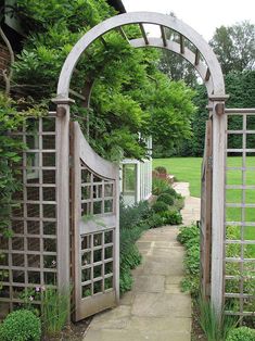 an arch in the middle of a garden