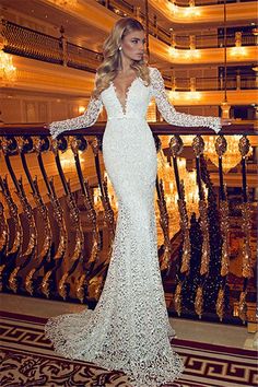 a woman in a white dress standing on a balcony