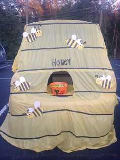 an inflatable beehive with the word honey on it and two bees flying around