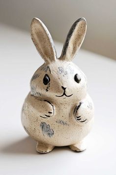 a ceramic rabbit figurine sitting on top of a table