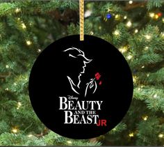 beauty and the beast ornament hanging on a christmas tree