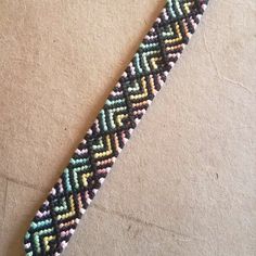 a close up of a beaded bracelet on a table