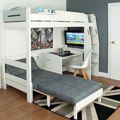 a white loft bed with desk and computer on it in a room that has hardwood floors