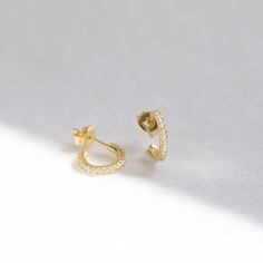 "These tiny open-hoop stud earrings are adorned with brilliant cubic zirconia gemstones. They're the perfect huggie hoop size for layering with other dainty hoops and studs. A dainty, elegant and versatile addition to your everyday lineup. ∙ Sold as a PAIR * D E T A I L S * ∙ Material: .925 Sterling Silver or 18K Gold Plated over .925 Sterling Silver ∙ Stone: White Cubic Zirconia ∙ Dimensions: Outer diameter: 11mm // Inner diameter: 7mm ∙ Hypoallergenic & nickel-free * P A C K A G I N G * ∙ Hypoallergenic Cubic Zirconia Hoop Piercings, Diamond Hoop Piercings As Gift, Minimalist Tarnish Resistant Cubic Zirconia Hoop Earrings, Diamond Hoop Piercings For Gifts, Minimalist Cubic Zirconia Hoop Diamond Earrings, Diamond Hoop Piercings, Small Hoop Earrings With Prong Setting, Dainty Hypoallergenic Hoop Diamond Earrings, Gift Cubic Zirconia Hoop Cartilage Earrings