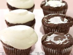 six chocolate cupcakes with white frosting on top